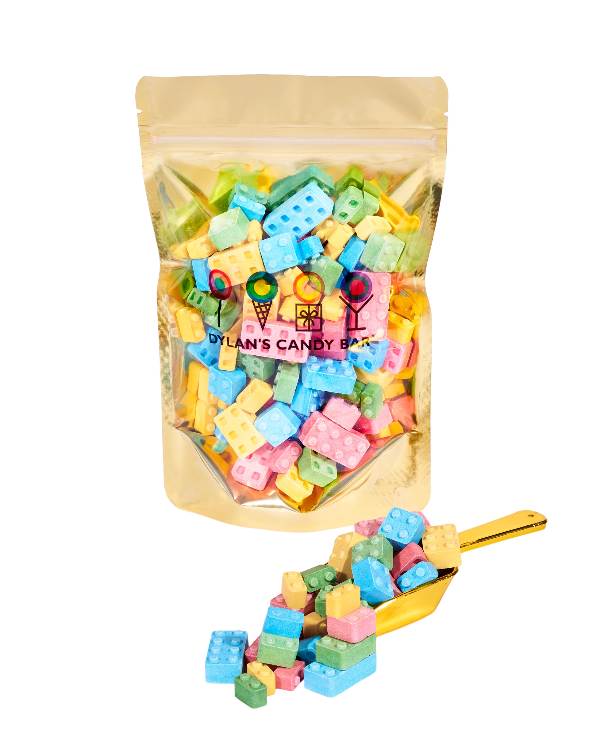 Fruity Pressed Candy Blox in resealable gold mylar bag next to Fruity Pressed Candy Blox overflowing from gold scoop